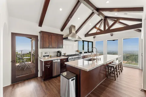 a kitchen with stainless steel appliances granite countertop a stove and a sink