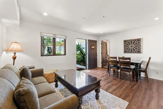 a dining room with furniture and wooden floor