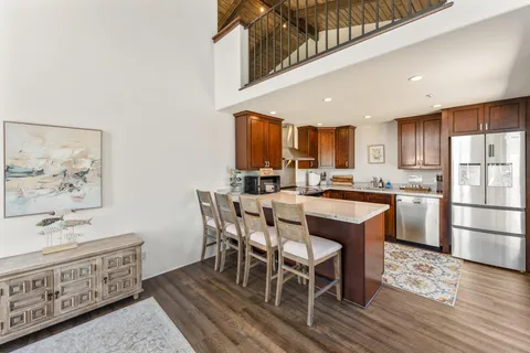 a living room with lots of furniture and a wooden floor