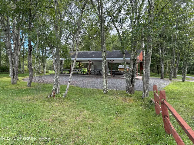a view of a yard with a wooden fence