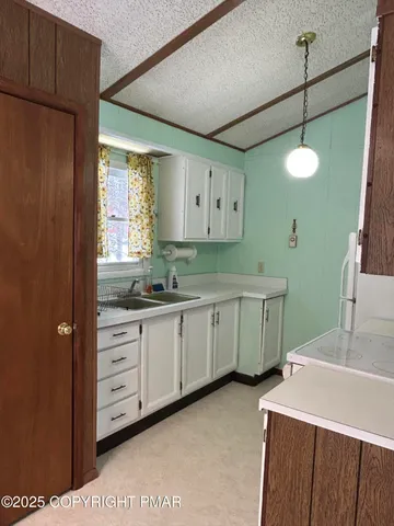 a utility room with cabinets washer and dryer