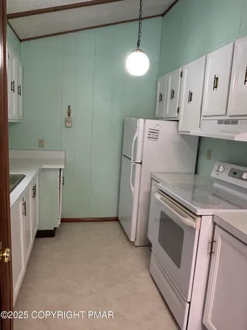 a dining room with wooden floor a chandelier a wooden table and chairs