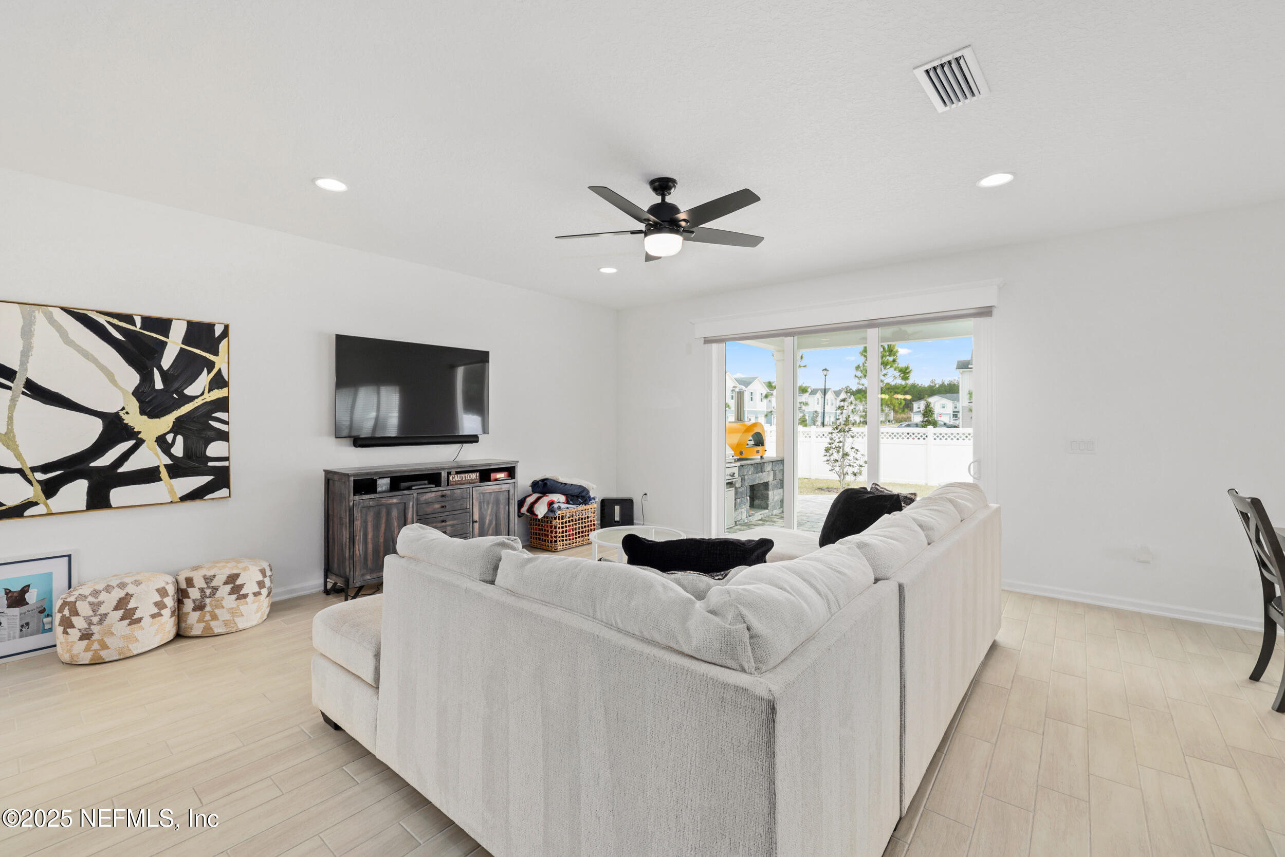 219 Goldcrest Way St. Augustine, FL 32092 - Photo 10 of 55 a living room with furniture a flat screen tv and a window