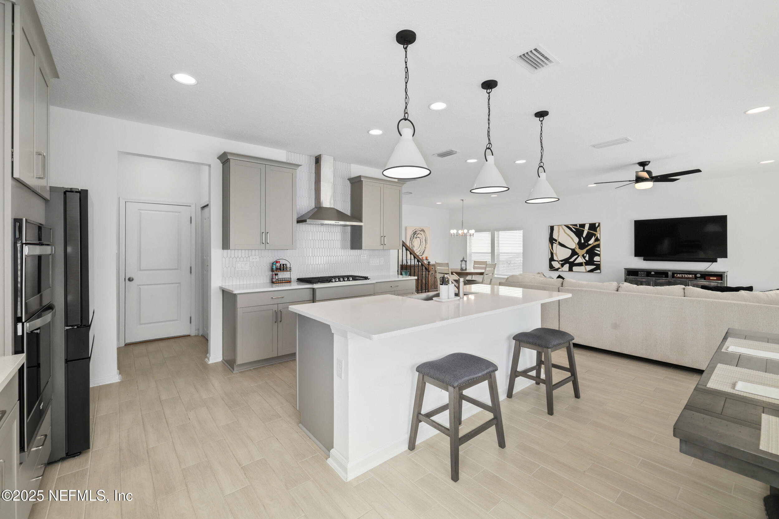 219 Goldcrest Way St. Augustine, FL 32092 - Photo 19 of 55 a kitchen with stainless steel appliances kitchen island granite countertop a sink and a refrigerator