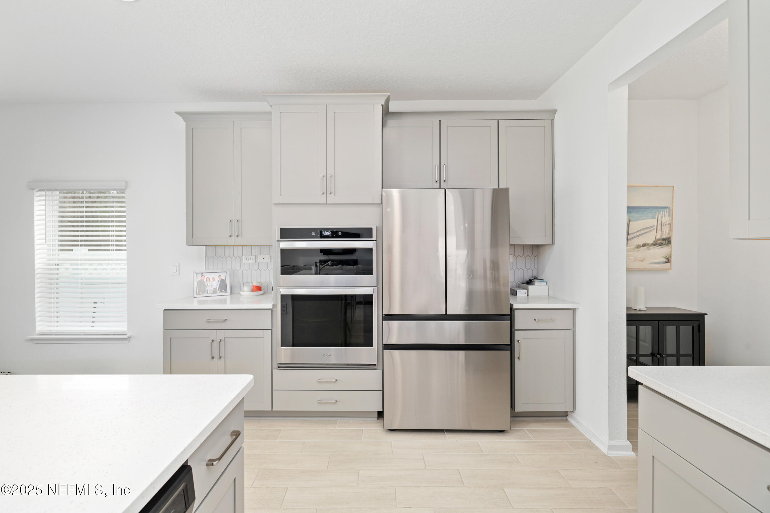 219 Goldcrest Way St. Augustine, FL 32092 - Photo 21 of 55 a kitchen with kitchen island white cabinets and refrigerator