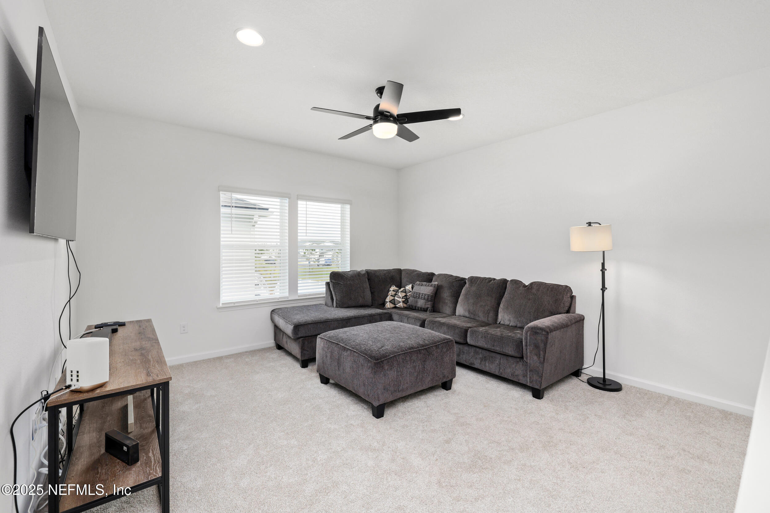 219 Goldcrest Way St. Augustine, FL 32092 - Photo 24 of 55 a living room with furniture a ceiling fan and a window