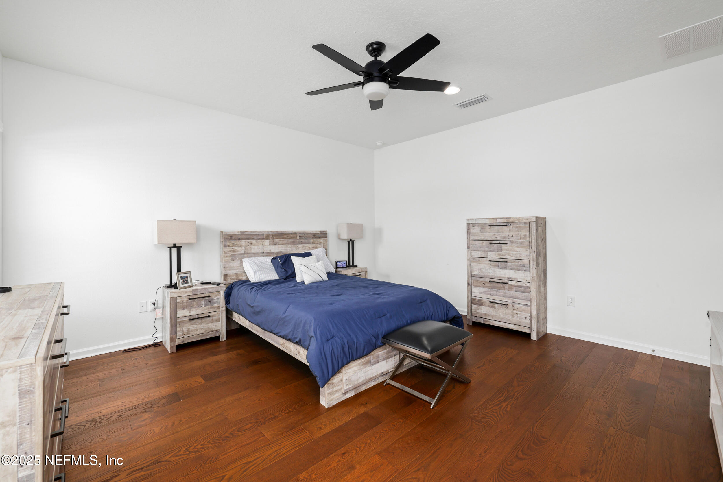 219 Goldcrest Way St. Augustine, FL 32092 - Photo 26 of 55 a bedroom with a bed and wooden floor