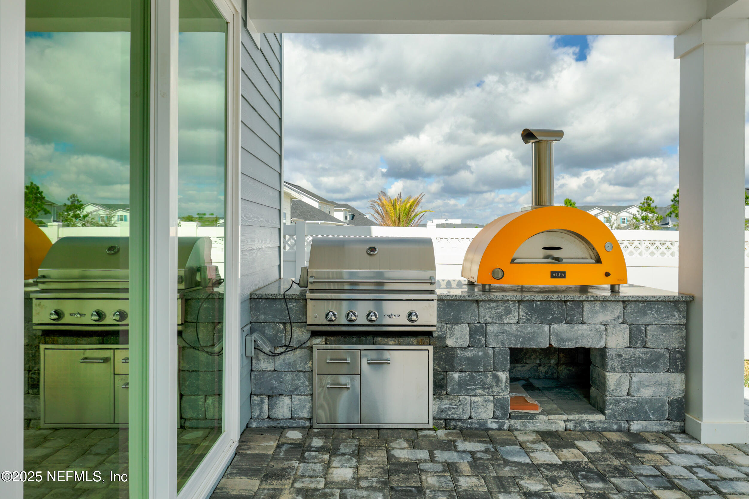 219 Goldcrest Way St. Augustine, FL 32092 - Photo 35 of 55 a kitchen with a stove and a fireplace