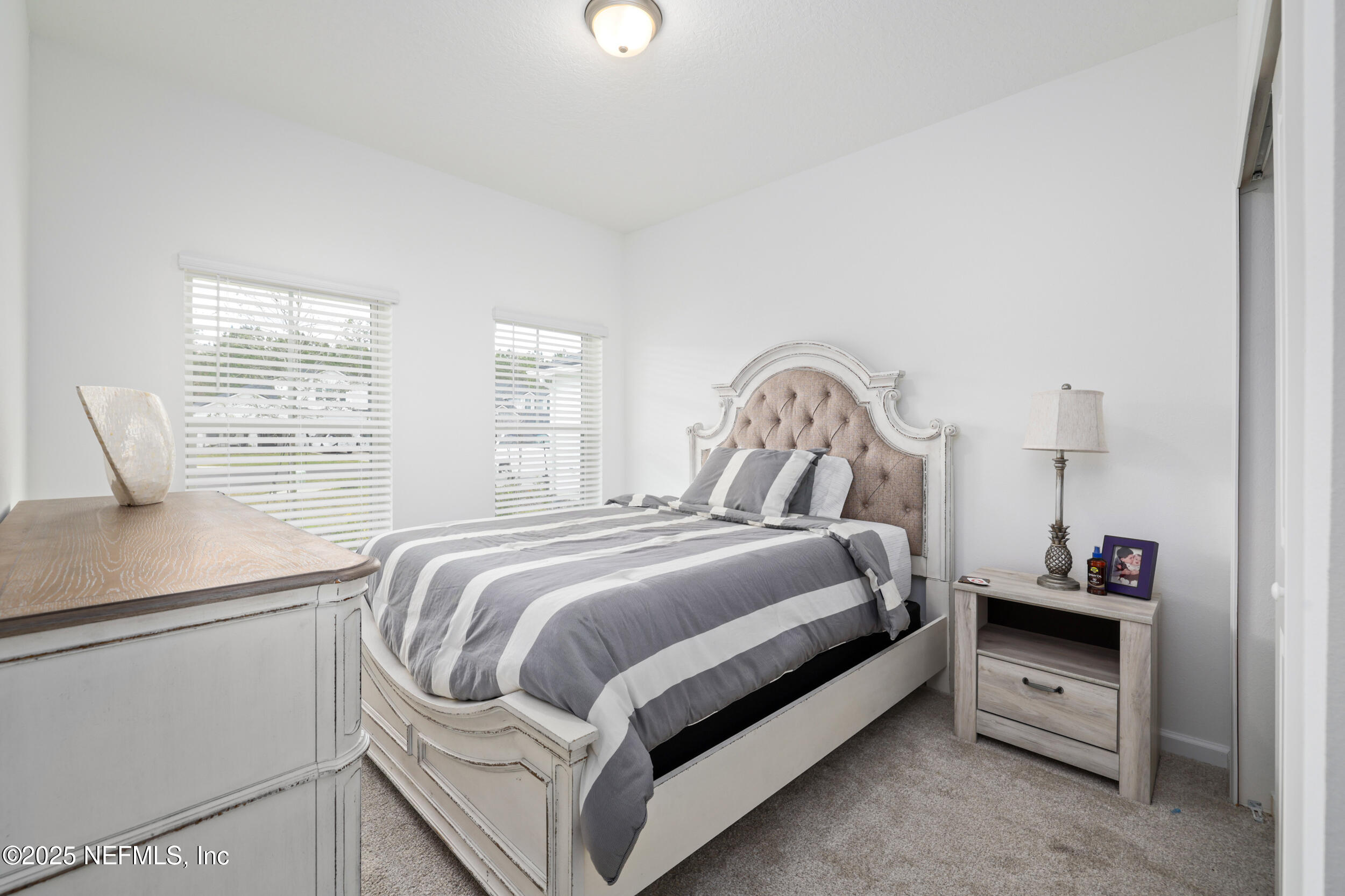 219 Goldcrest Way St. Augustine, FL 32092 - Photo 7 of 55 a bedroom with a bed and a window