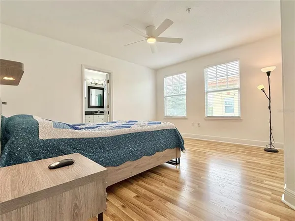 a living room with hard wood floors and a ceiling fan