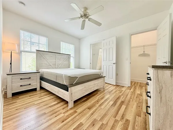 a bedroom with a bed and a chandelier