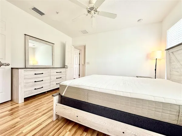 a bedroom with a bed and a dresser