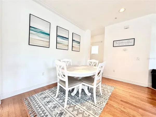 a view of a dining room with furniture and wooden floor
