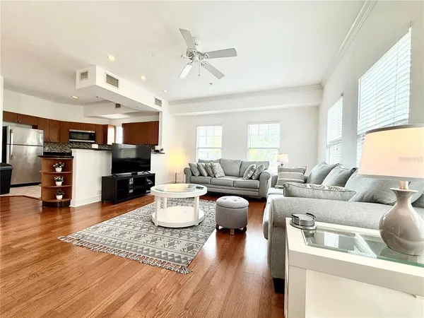 a living room with furniture and wooden floor
