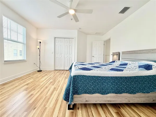 a bed sitting in a bedroom next to a window