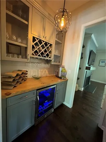 a kitchen with stainless steel appliances a dining table chairs stove and refrigerator