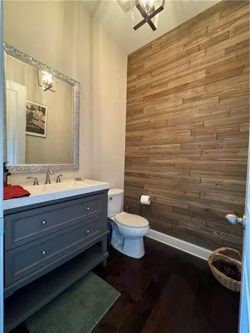 a kitchen with stainless steel appliances a dining table chairs stove refrigerator and cabinets