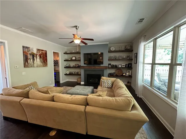 a kitchen with stainless steel appliances kitchen island granite countertop a stove refrigerator and cabinets