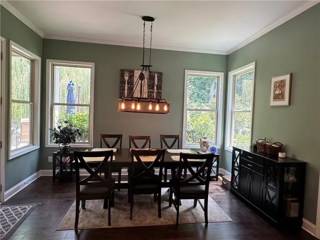 a bathroom with a sink a toilet a mirror and shower