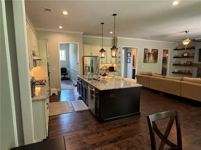 a living room with furniture a flat screen tv and a window