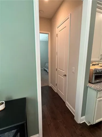 a bedroom with a bed and a flat tv screen on the dresser