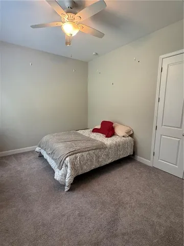 a spacious bedroom with a bed and a chandelier