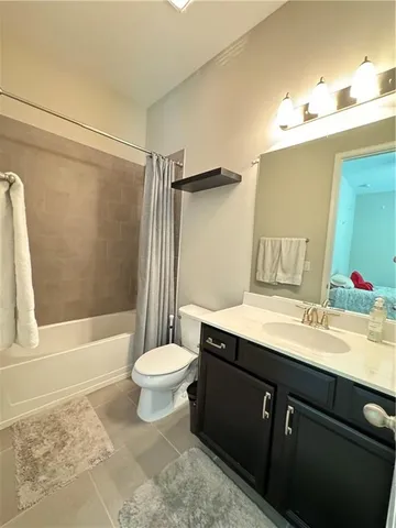 a bedroom with a bed and a ceiling fan