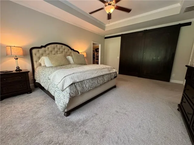 a spacious bathroom with a granite countertop sink a toilet a mirror and shower