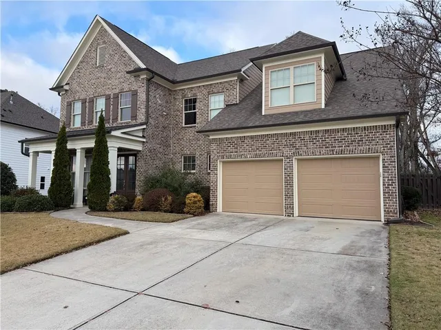 a view of a house with a iron fence