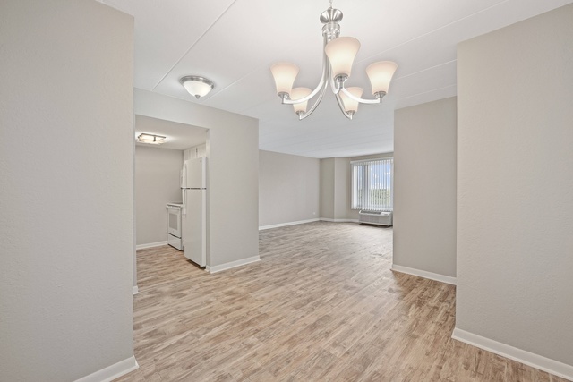1 Renaissance Place, Unit 719 Palatine, IL 60067 - Photo 3 of 20 wooden floor in an empty room with a window