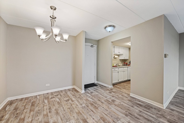 1 Renaissance Place, Unit 719 Palatine, IL 60067 - Photo 5 of 20 a view of a kitchen with a sink and dishwasher with wooden floor