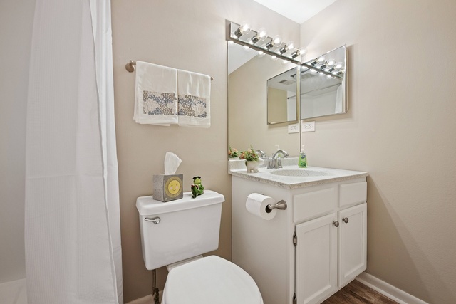 1 Renaissance Place, Unit 719 Palatine, IL 60067 - Photo 9 of 20 a bathroom with a toilet a sink a mirror and a shower