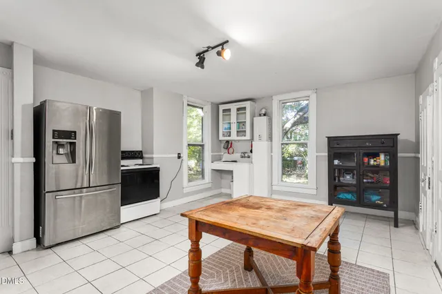 a kitchen with stainless steel appliances kitchen island granite countertop a refrigerator and a stove top oven