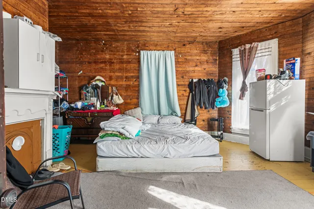 a living room with furniture and a painting on the wall