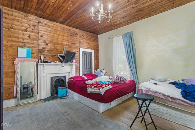 a bedroom with a bed a standing couch and a window