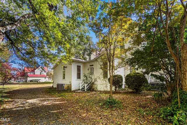 a view of a white house with a yard