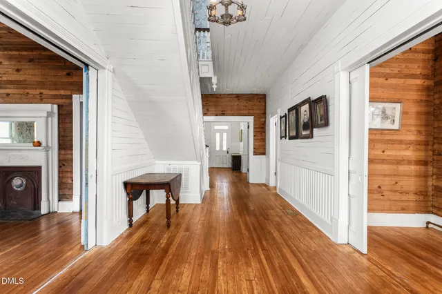 a bedroom with wooden floor and a window