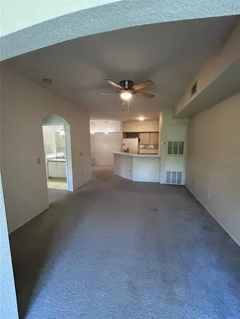 a view of a kitchen and a empty room