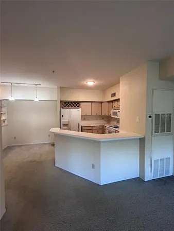 a kitchen with stainless steel appliances granite countertop a sink and a refrigerator