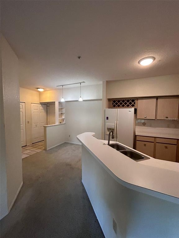 832 Camargo Way, Unit 303 Altamonte Springs, FL 32714 - Photo 19 of 27 a kitchen with stainless steel appliances granite countertop a sink and a refrigerator