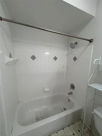 a bathroom with a granite countertop sink a mirror and a shower