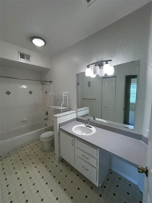 832 Camargo Way, Unit 303 Altamonte Springs, FL 32714 - Photo 5 of 27 a bathroom with a sink a toilet a large mirror and shower