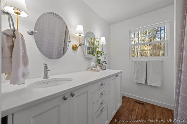 a bathroom with a double vanity sink and a mirror