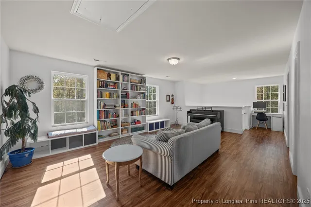 a living room with furniture and a book shelf