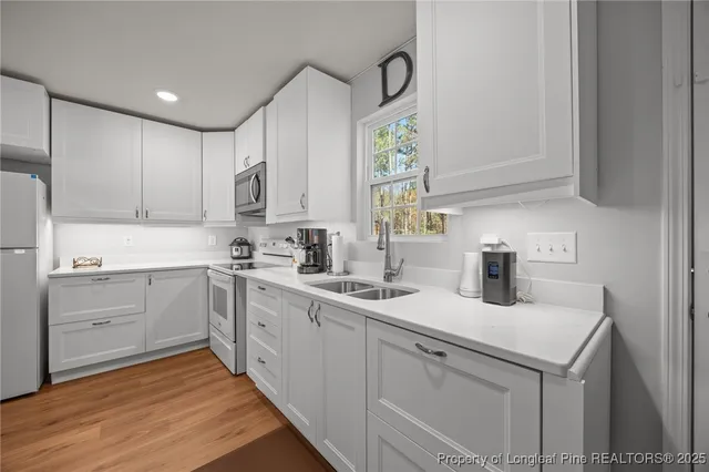 a kitchen with a sink cabinets and window