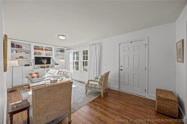 a living room with furniture and flat screen tv