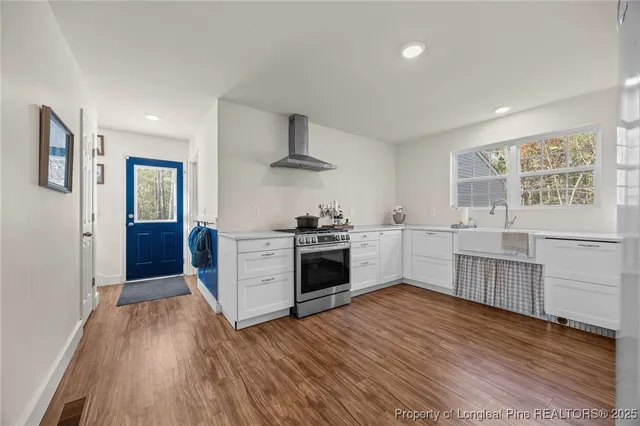 a kitchen with stainless steel appliances a white stove top oven and a refrigerator