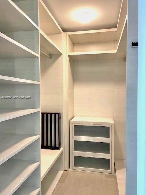 68 Southeast 6th Street, Unit 2507 Miami, FL 33131 - Photo 13 of 47 a view of walk in closet with empty racks