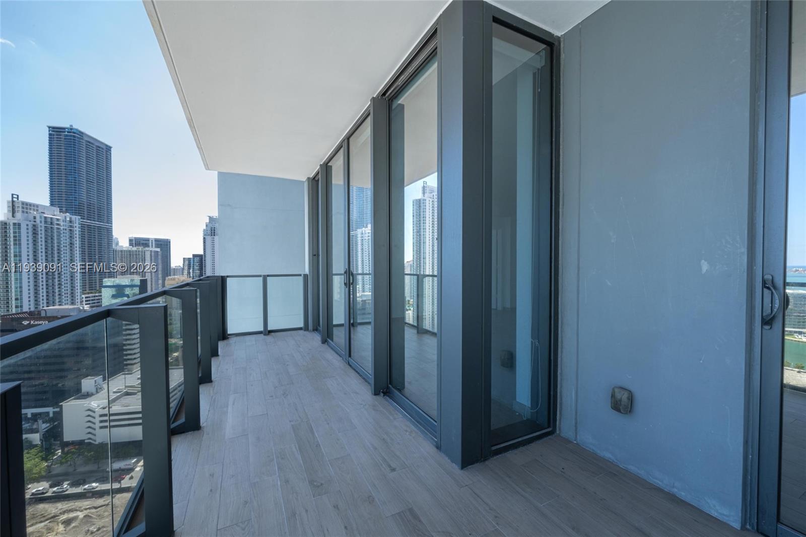 68 Southeast 6th Street, Unit 2507 Miami, FL 33131 - Photo 4 of 47 a view of a hallway with wooden floor and staircase
