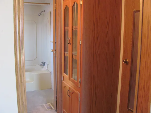 a bathroom with a granite countertop shower and a sink